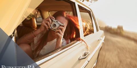 woman on road trip taking picture